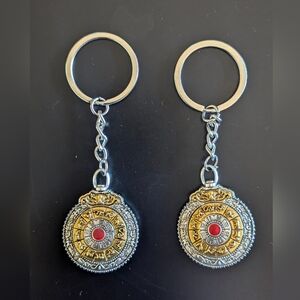 A Pair Of Buddhist Zodiac Sign Blue and Red Pendant Style Keychains For Couples